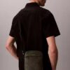 Bolso tipo reporter con logotipo en relieve por toda la superficie