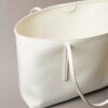 Bolso tote con el logotipo del emblema por toda la superficie y bolsillo Bolso tote con el logotipo del emblema por toda la superficie y bolsillo