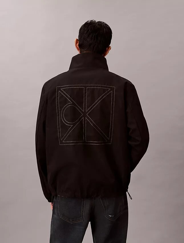 Chaqueta reversible con logotipo en todo el tejido Chaqueta reversible con logotipo en todo el tejido