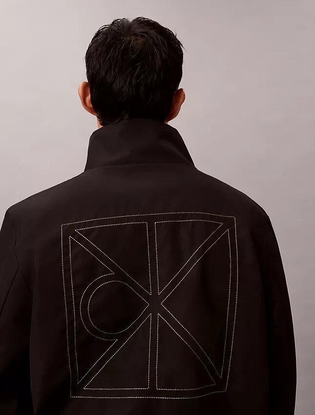 Chaqueta reversible con logotipo en todo el tejido Chaqueta reversible con logotipo en todo el tejido