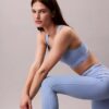 Leggings deportivos modernos de talle alto con logo en la cintura y corte 7/8